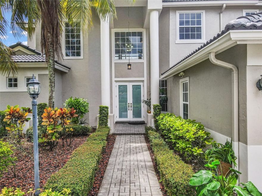 Welcome to this stunning waterfront home in the prestigious Parkland Isles community. This Mariner 6 model features 6 bedrooms, 4 full baths, 3 garages, and a pool, ideally set on a peaceful lakefront lot in Bayside Estates. The bright, open layout includes a master suite plus an additional bedroom & bath on the first floor. Highlights include dual staircases, an upgraded kitchen with newer appliances, rich wood cabinetry, and double ovens. Perfect for entertaining, the home offers formal dining, a family room with wet bar, and a spacious patio with a 2020 screen, 2023 retractable awning, and resurfaced pool. Additional upgrades: impact windows, doors, garage doors, and newer A/C units. Enjoy resort-style amenities and top-rated schools, A true delight for outdoor lovers!!