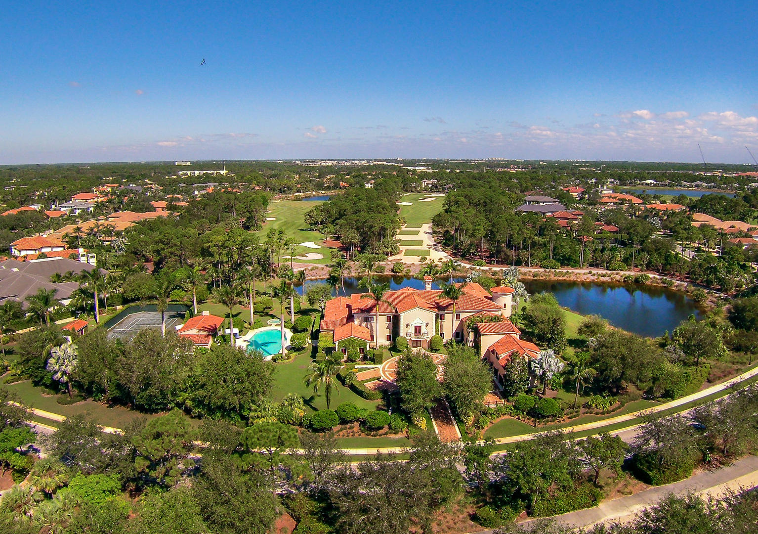 Situated on two acres of private meticulously landscaped grounds, panoramic lake and golf course views surround this custom residence with the feel of a modern-day palazzo. Elegantly crafted with fine finishings, custom moldings, oasis like outdoor accommodations. private tennis court, custom large pool, several covered loggia/entertaining areas, bar and full summer kitchen. This exceptional 6-bedroom 10.1 bath, +/-16,860 total sq. ft. located in Old Palm, hailed as one of the most exquisite clubs in the world featuring a 18-hole Raymond Floyd designed Championship Golf Course, state of the art practice studio, full service salon and spa, private dining, wine room, beach club access, and fitness room with private instruction.