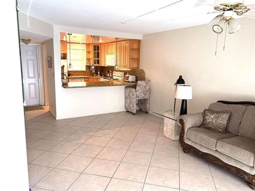 MOTIVATED SELLER! Located in the famous Tennis Club of Ft Lauderdale along the Middle River, you walk into a tropical Courtyard, entering into a spacious updated Apt., tiled throughout. Has an open kitchen with granite counter tops, custom cabinets, recessed lighting & matching appliances. Large Living Room leads into a private screened-in balcony, with a great view of the river. Split roomy bedrooms with tile floors. Bathrooms updated. Adjacent to the bldg. is a convenient private pathway that leads to all the ameniities --20 Clay Tennis Cts., (10 Lighted), 3 Hard Cts., Heated Pool, Spa, fully equipped Gym, full service Patio Bar & Grille - Gated Community, manned 24/7 Security makes you feel so safe. Close to beaches, downtown Ft Lauderdale, Wilton Manors, I-95 & Airport.