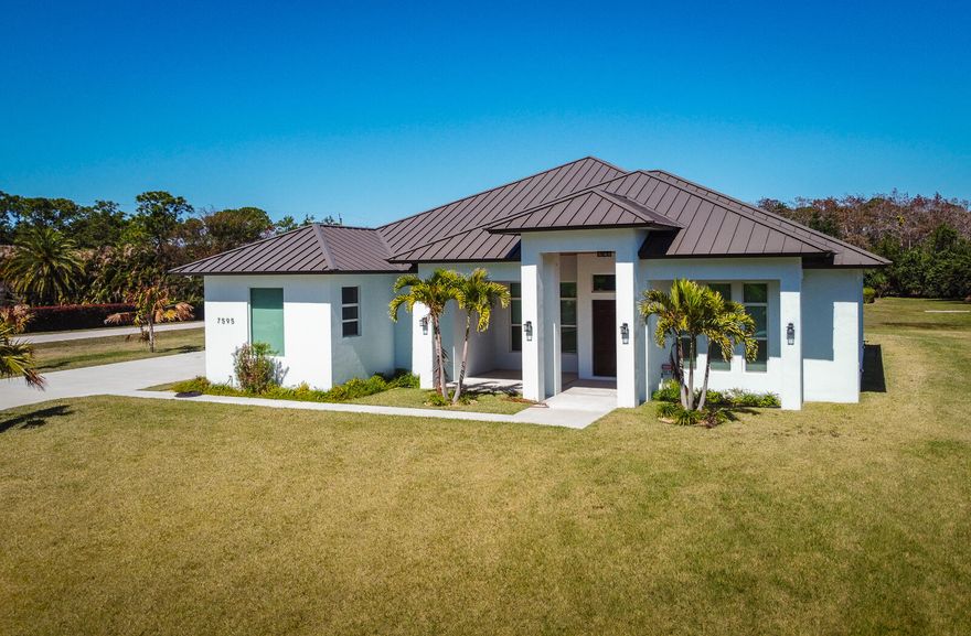 This BRAND-NEW luxury CBS home located on a 1.16-acre corner lot on a paved road in Palm Beach Country Estates features 5 bedrooms plus a den, 4.5 baths, and an oversized 2-car garage. Metal roof and hurricane impact windows. Luxury finishes and 12-foot ceilings throughout. Split floorplan with enormous great room at the center. An underground propane tank supplies the kitchen range, water heater, and summer kitchen. Open kitchen with high-end stainless-steel appliances and large center island. Master bedroom features two large walk-in closets and a master bath with standalone bathtub, dual vanities, and separate shower. Hobby/bonus room off the great room with lots of sunlight. Two A/C zones. Large covered porch with frameless screen. Opportunities to purchase a brand-new home in this subdivision are rare -very few vacant lots left. Palm Beach Country Estates features quiet country living with no HOA, city water, and close proximity to area amenities such as Alton Town Center and Abacoa.