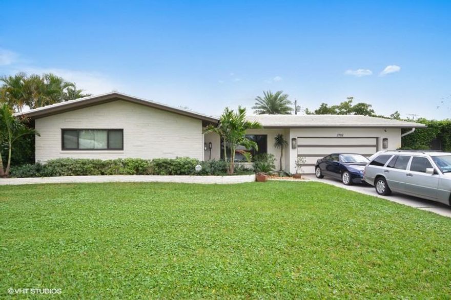 Spectacular Mid Century Renovation! This remarkable 3 bedroom, 2 bath home with den, pool & garage has been renovated to meet today's highest standards. Quiet décor to match the elegant space and beautiful landscaping make this a home to be envied. The slate patio entry is enhanced with tropical plantings and leads to the front entrance with side light and decorative touches. A large foyer allows the sight line to flow from the living room into the dining room and beyond the family room to a window wall allowing the outside to become part of the interior space. Contemporary neutral tile rectangle flooring flows throughout and makes for an engaging yet warm and inviting interior. The updated custom kitchen has wonderful white cabinets with chrome accent hardware, double bowl stainless steel sink and appliances with granite countertops and a craftily hidden laundry disguised as a pantry. Sure to delight is the massive master bedroom suite with its own foyer, walk-in closet and entry to the grand rear yard with pool, banana trees, palms and plantings. The master ensuite bath has a marble shower and great vanity with enamel sink, while the guest bathroom enjoys a spacious shower, beautiful vanity and custom wall treatment. . A large Family Room 26X11.6 allows room for lounging, dining and quiet contemplation while leading to a custom awninged patio for poolside entertainment. Finishes throughout the home achieve the latest decorative colors to enhance each space. This home has the best in move in ready finishes and welcomes you from the very curb appeal!