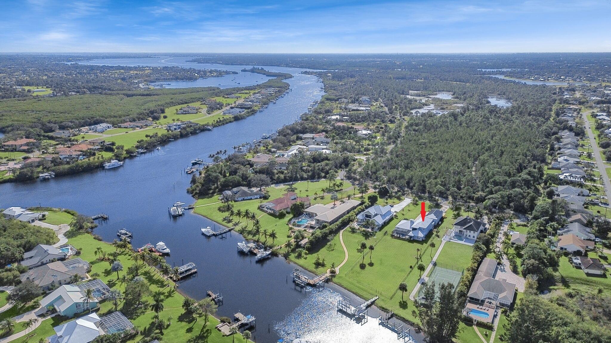Custom-built in 2019 to match your unlimited life. RV-ready garage with 16-foot clearance door, AND an additional 3 car garage, for almost 2,250sf feet of garage! For real motor enthusiasts, the garage is foam-filled CBS and ready for climate control. Deep water dockage with 2 lifts (24k and 16k) in the North Fork of the St. Lucie River, with direct ocean access! Home has Cat-6 integration, 48KW generator & 1k gallon tank, solar panels, complete impact windows/doors & salt water pool. Main home has four, possible five bedrooms, with upstairs & downstairs master suites. PLUS, find an attached casita/in-law studio with full bath and separate entrance, ready for kitchen install. Vikings Lookout is a gated upscale waterfront community with easy access to highways.