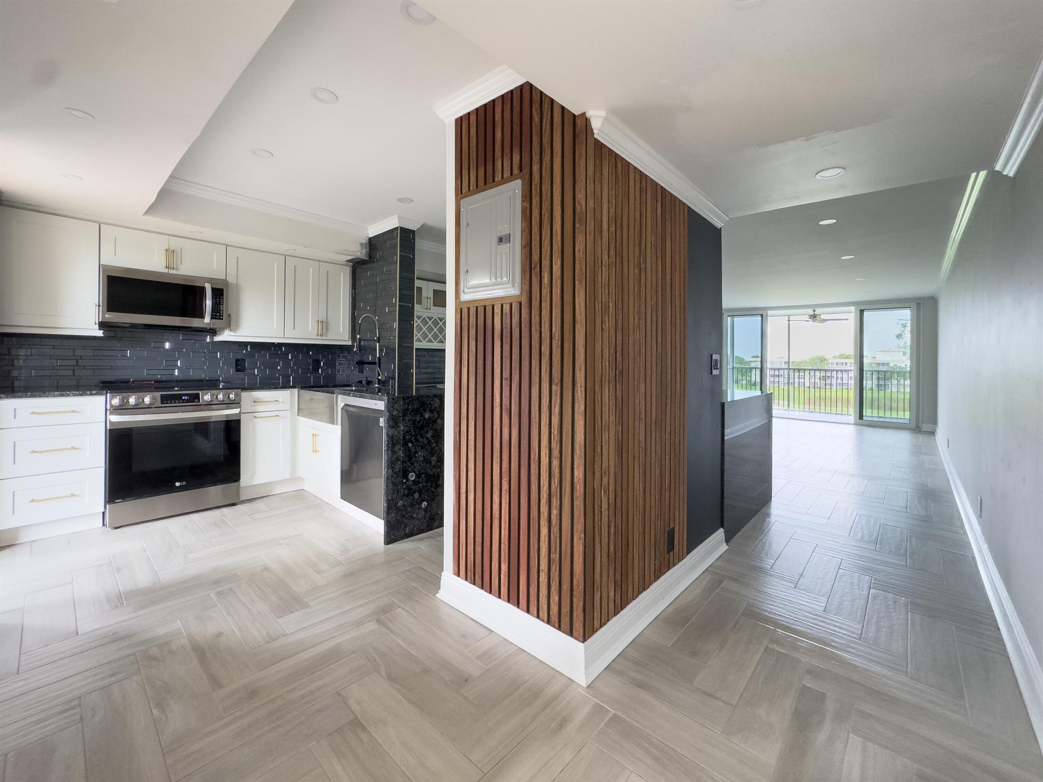 Beautifully renovated 2-bedroom, 2-bath condo in desirable Palm Aire! This spacious unit features a one-of-a-kind open kitchen concept unlike any other in PACC 2, offering a seamless layout and matching floor-to-ceiling tile throughout for a clean, modern feel.Entertain with ease in the sleek kitchen, complete with stainless steel appliances and a bonus mini fridge in the custom bar area. All major systems -- A/C, HVAC, water heater, and electrical panel -- were replaced just 2 years ago for added peace of mind and comfort.All windows and sliding glass doors are impact-rated, newly installed two years ago, providing enhanced safety, energy efficiency, and hurricane protection.This is a rare opportunity to own one of the largest and most unique layouts in the neighborhood.