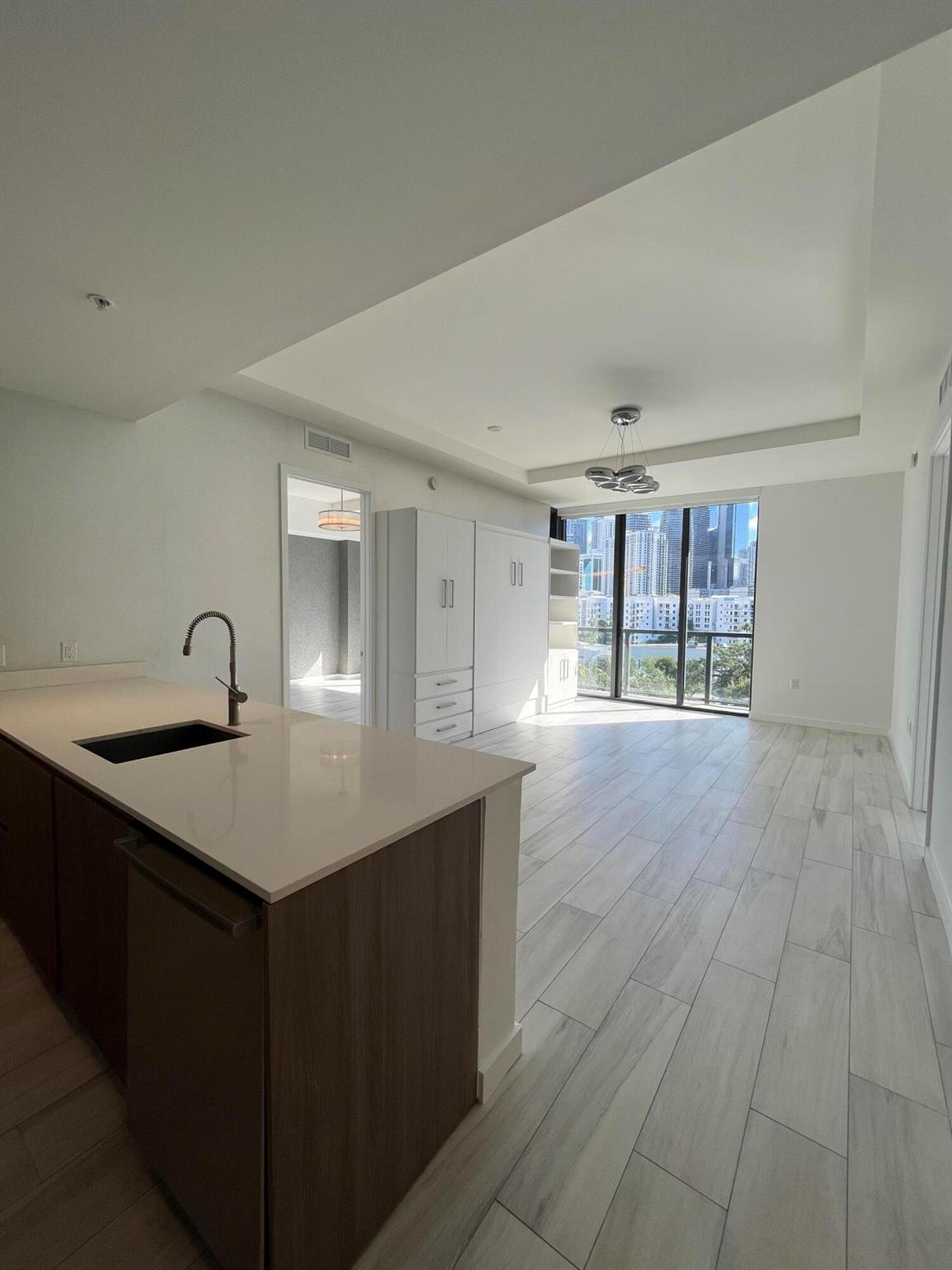 Penthouse living in the heart of Brickell! This stunning unit offers sleek, neutral finishes with a modern design. The home features a custom-built Murphy bed unit with plenty of extra storage, high-end Bosch appliances, and a new washer/dryer. Automatic shades throughout, with blackout shades in the bedrooms. Both bedrooms include spacious walk-in closets.The building's amenities are equally impressive: rooftop infinity-edge pool, hot tub, sauna, shower, and state-of-the-art gym. (Pool deck under renovation with completion anticipated October-November; gym remains open.)This PH unit includes two tandem parking spaces, a 5x5 storage unit, and is pet-friendly (25 lbs. and under). Experience luxury, convenience, and the vibrant Brickell lifestyle at its best!
