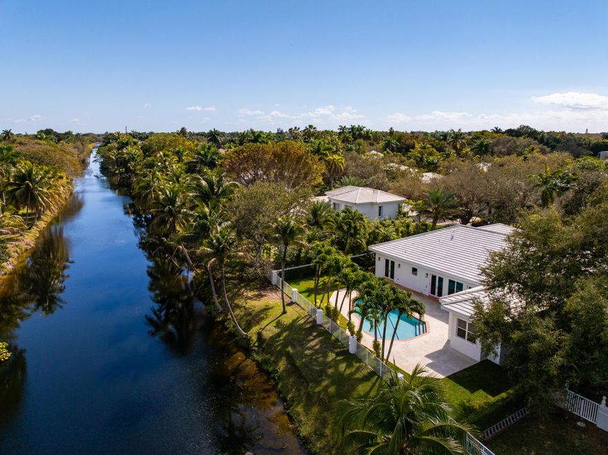 Tucked within the gated enclave of Silvercreek, this turnkey canal-front residence offers a rare blend of privacy, security, and effortless indoor-outdoor living in the heart of Pinecrest. Thoughtfully renovated with 10' ceilings, the home unfolds with light-filled interiors, generous living spaces, and a seamless connection to the outdoors. Expansive impact glass openings invite natural light throughout, enhancing the home's clean lines and sophisticated finishes. The chef's kitchen serves as the centerpiece designed for both everyday living and entertaining. Located just moments from top-rated schools, parks, and the best of Pinecrest living, this residence offers a compelling opportunity to enjoy a move-in-ready home within one of the area's most desirable and discreet communities.