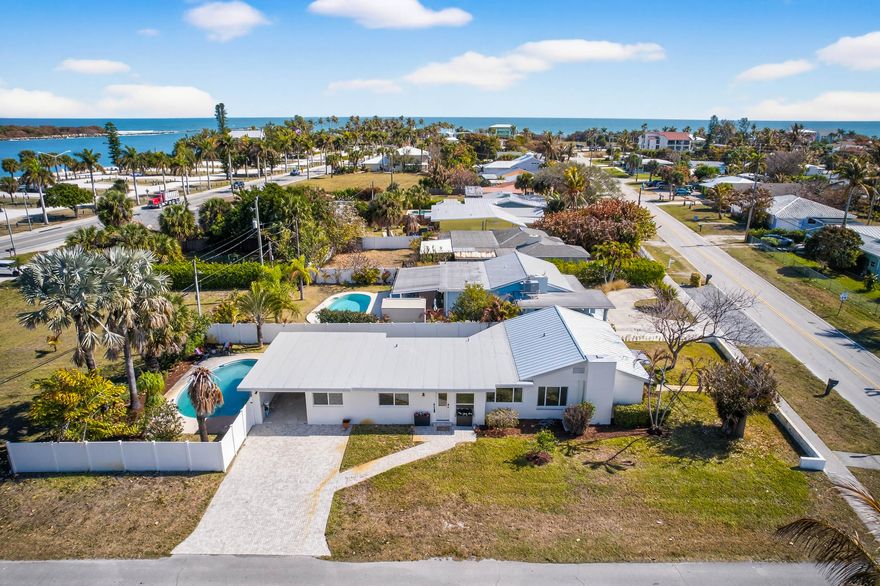 This home offers Island living at its Finest!  Walk to beaches, restaurants and all of the best entertainment South Hutchinson Island have to offer or take a quick Freebie ride to downtown Fort Pierce.  This four bedroom, two and one-half bathroom home has been partially renovated with impact windows and doors throughout, laminate wood flooring, new metal roof, 2021 A/C, brick paver driveway, new bathroom and white vinyl fencing!  You can make the rest of the home your own by renovating the kitchen and making the back bedrooms a large master suite with views of the intercoastal.  Enjoy breathtaking views of the Fort Pierce Inlet while relaxing by the pool.  This home has it all!  Seller is open to seller financing with agreeable terms.