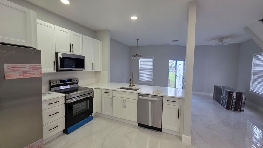 This completely renovated townhouse awaits its next tenant . A sleek, modern kitchen is the centerpiece, featuring brand-new stainless steel appliances and stunning quartz countertops. Elegant new flooring flows throughout the living spaces, complementing the beautiful, freshly painted walls. Both bathrooms have been stylishly updated. Conveniently located near major highways and schools, this residence offers modern convenience in a prime location.