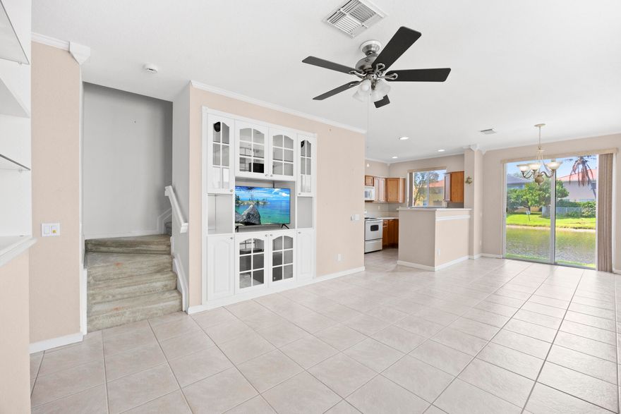 Stunning 2-bedroom, 2.1-bath townhouse with updates throughout! Features include newer bathroom vanities, new shower doors, AC installed in 2022, tile on the main floor, carpet upstairs, and washer & dryer conveniently located on the second floor. The kitchen boasts beige Maytag appliances, and accordion shutters provide added protection.

Relax with serene lake views from the master suite, which includes an LG TV with custom stand. The living room features a TV with Theater Research speakers. Spacious closets include a safe in the master, and built-in garage shelving adds extra storage. Move-in ready and designed for comfort and convenience!