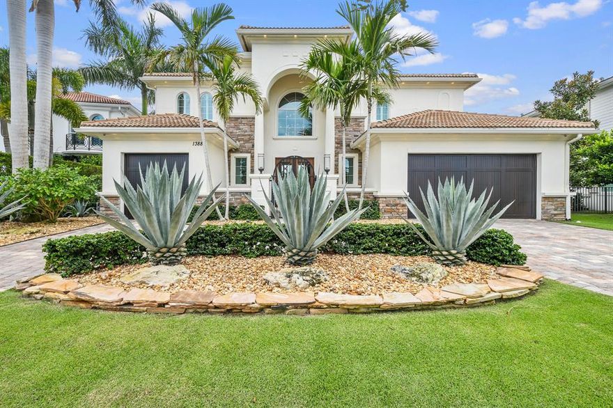 Stunning New Construction Estate on the Waterfront with Private Dock and Lift! Chic and elegant, this home was professionally designed and finished in the style of European Luxury. Located in the highly coveted community of Frenchman's Harbor, this spacious floorplan boasts 5 bedrooms, a den and 5 bathrooms with over 4700 square feet under air. Situated on a serene canal just off the Intracoastal with over 80 feet of waterfrontage, easy ocean access, no fixed bridges and a private 45 foot dock. The oversized backyard is ideal for enjoying the ultimate Florida lifestyle, with upgraded landscaping, a saltwater pool/spa, custom gas fire pedestals, and outdoor lanai with summer kitchen that makes entertaining a breeze.