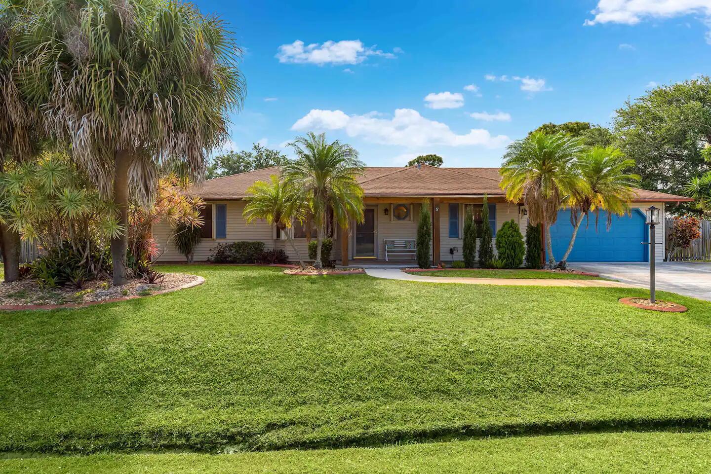 Picture yourself sipping cocktails under your tiki roof while palms sway in the breeze in your private retreat! Fenced double lot (nearly 1/2 acre), is a rare gem, nestled in a quiet neighborhood east of US-1 with NO HOA, and just minutes from the beach!. The outdoor tiki living area, great for entertaining, overlooks a dazzling pool and spa. The main house boasts 2 king bedrooms and 2 baths, while the charming 1 bedroom, 1 bath Guest House - suitable for in-laws, teens, or guests - features mini-split AC and a tankless water heater overlooking the shimmering pool. NEW ROOF in 2024, and 10-minutes from downtown Stuart or Jensen Beach. Don't miss this chance to live the ultimate tropical lifestyle!