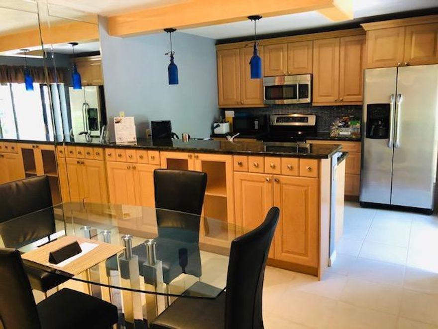 Lakes at the Bluffs TH 2 bedroom, 2.5 bath with a private screen enclosed, tiled courtyard. 
New open kitchen with custom wood cabinets with granite counter-tops and stainless steel appliances. (microwave not working) AS IS. Tile floors on main level and wood floors upstairs in bedrooms. Remodeled shower in master bath. Amenities at the Lakes at the Bluffs include: Olympic sized heated pool overlooking a lake, tennis courts, children's playground, hand ball courts. Walk to Beach in 5 minutes, close to Publix, shoppes etc.