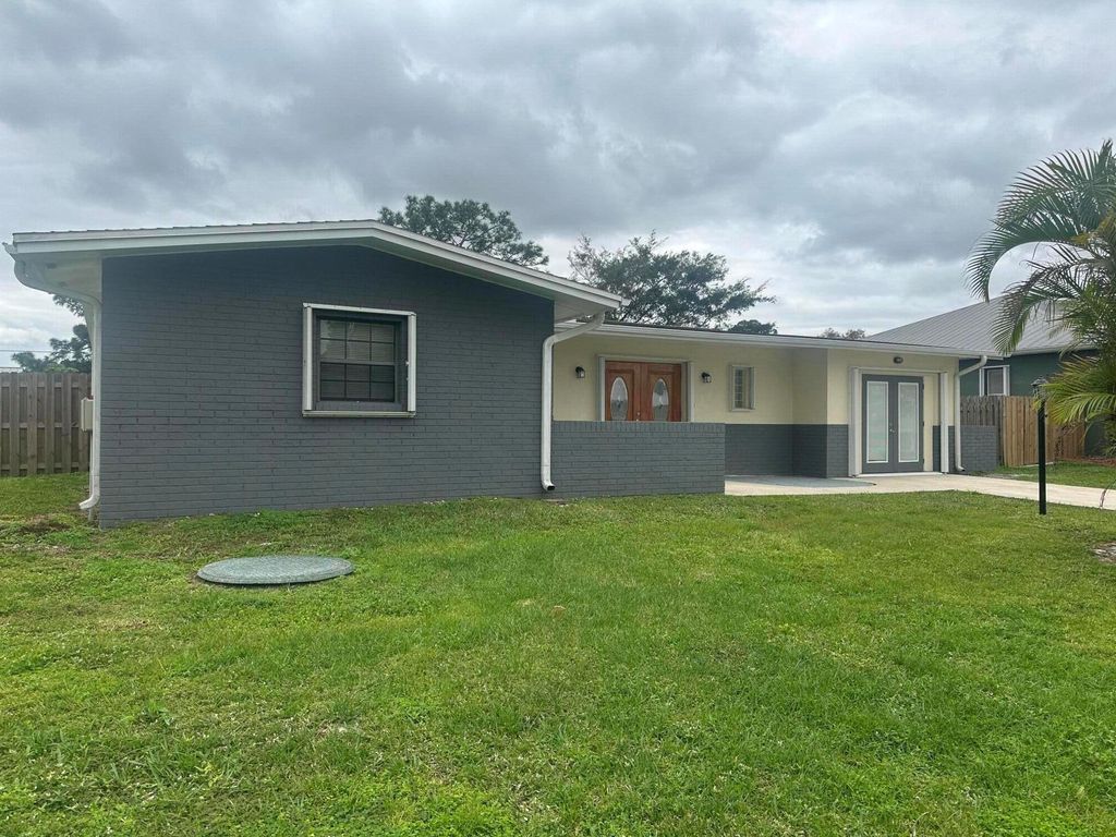 Photo of 950 SE Belfast Avenue, Port Saint Lucie, FL 34983 (MLS # R10952486)