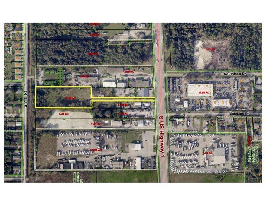 Protected, private 2.76 acres with access off US1, zoned Light Industrial for many, many uses! Great Location in busy commercial US1 location.