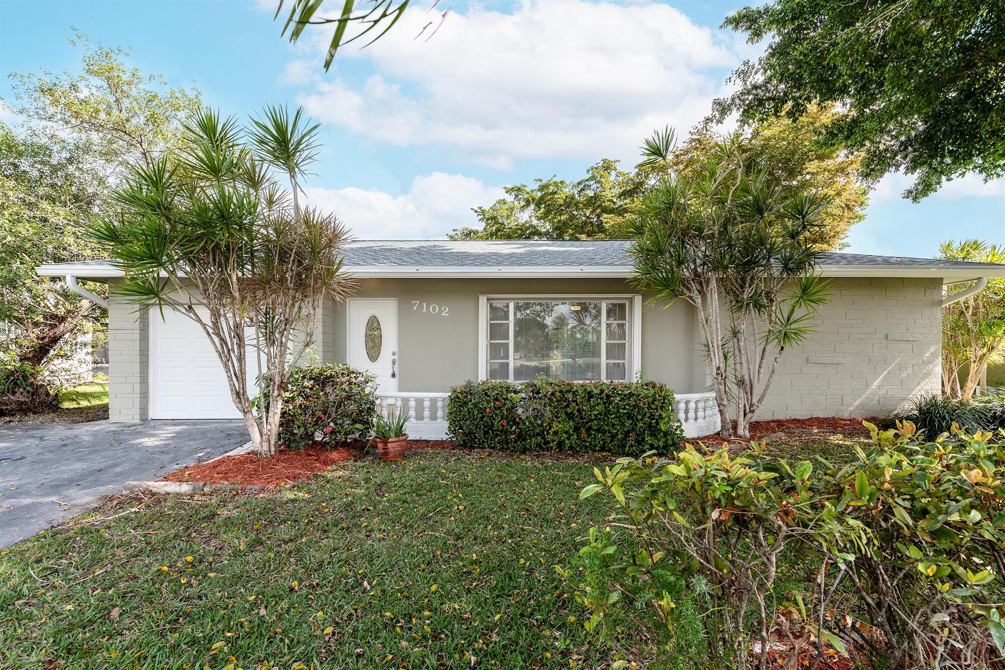 Enjoy stunning waterfront views from this beautifully updated 2-bedroom, 2-bathroom single-family home in Westwood 4 of Tamarac, sought-after 55+ community. This charming residence boasts a new roof, new garage door, 2018 AC, and a completely remodeled kitchen with white shaker cabinets, granite countertops, and stainless steel appliances. The open split floorplan features new laminate flooring throughout and two elegantly updated bathrooms. Relax year-round in the expansive Florida room with a separate AC unit or enjoy fresh air in the covered, screened-in patio. Situated on a large lot with a mature mango tree, this home offers a serene canal/lake view that's perfect for tranquil living. Don't miss this rare gem!