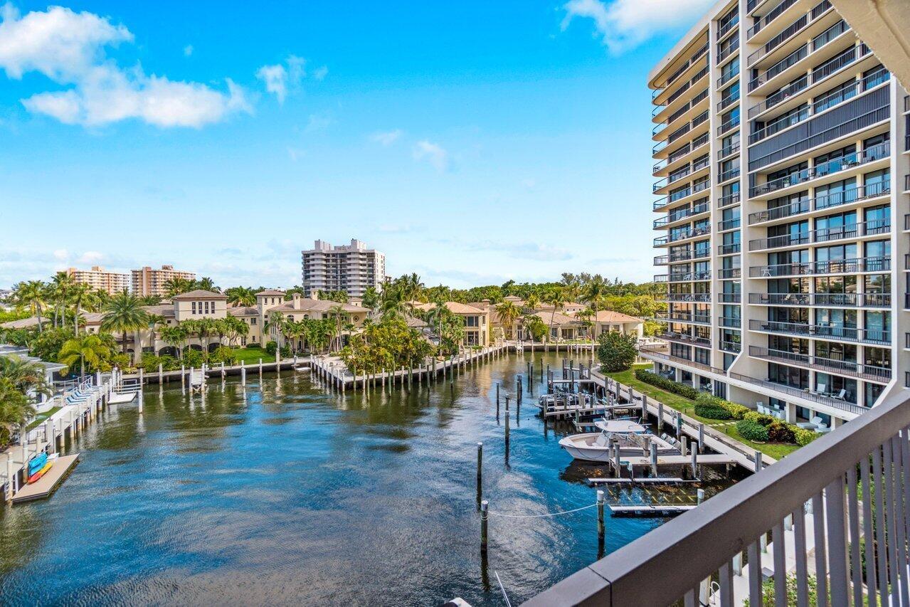 Experience luxury living in this stunning corner unit located in the highly sought-after Braemar Isle Boca Highlands. Situated on the North Marina, enjoy peaceful & serene views of private homes, while the side facing the intracoastal provides breathtaking water views.Floor-to-ceiling impact sliding doors flood the space with natural light. All bedrooms are equipped with motorized window treatments.The recently remodeled kitchen features a bar that spans the entire length, perfect for entertaining. Beautiful Italian travertine floors throughout. The living room lighting is accented with Swarovski crystal for added elegance. Step out to the wrap-around patio, fully furnished with high-end Skyline and Kannoa furniture, and enjoy the spectacular views of the marina and intracoastal.