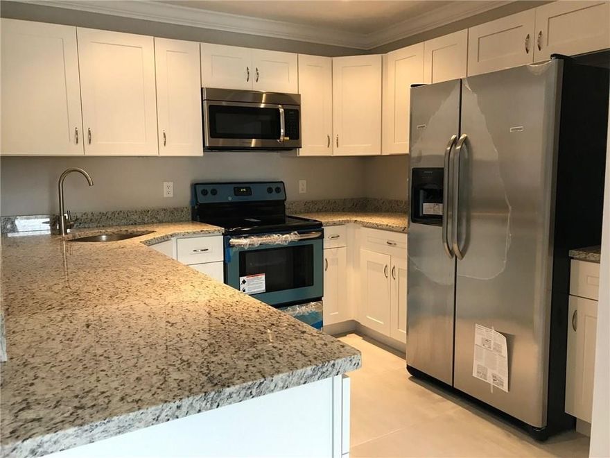 They went all out!!! Completely renovated 2 bedroom 2 bath in Karanda Village 6 of the Township. Brand new kitchen with solid wood cabinets, granite tops, and SS appliances. Both bathrooms completely renovated with new tile, showers, and vanities.  New tile floors in living area and laminate in the bedrooms. Freshly painted and crown molding through out. This is the best one yet! Will not last long! Assoc fee $365 a month and master assoc fee  $140 a quarter.