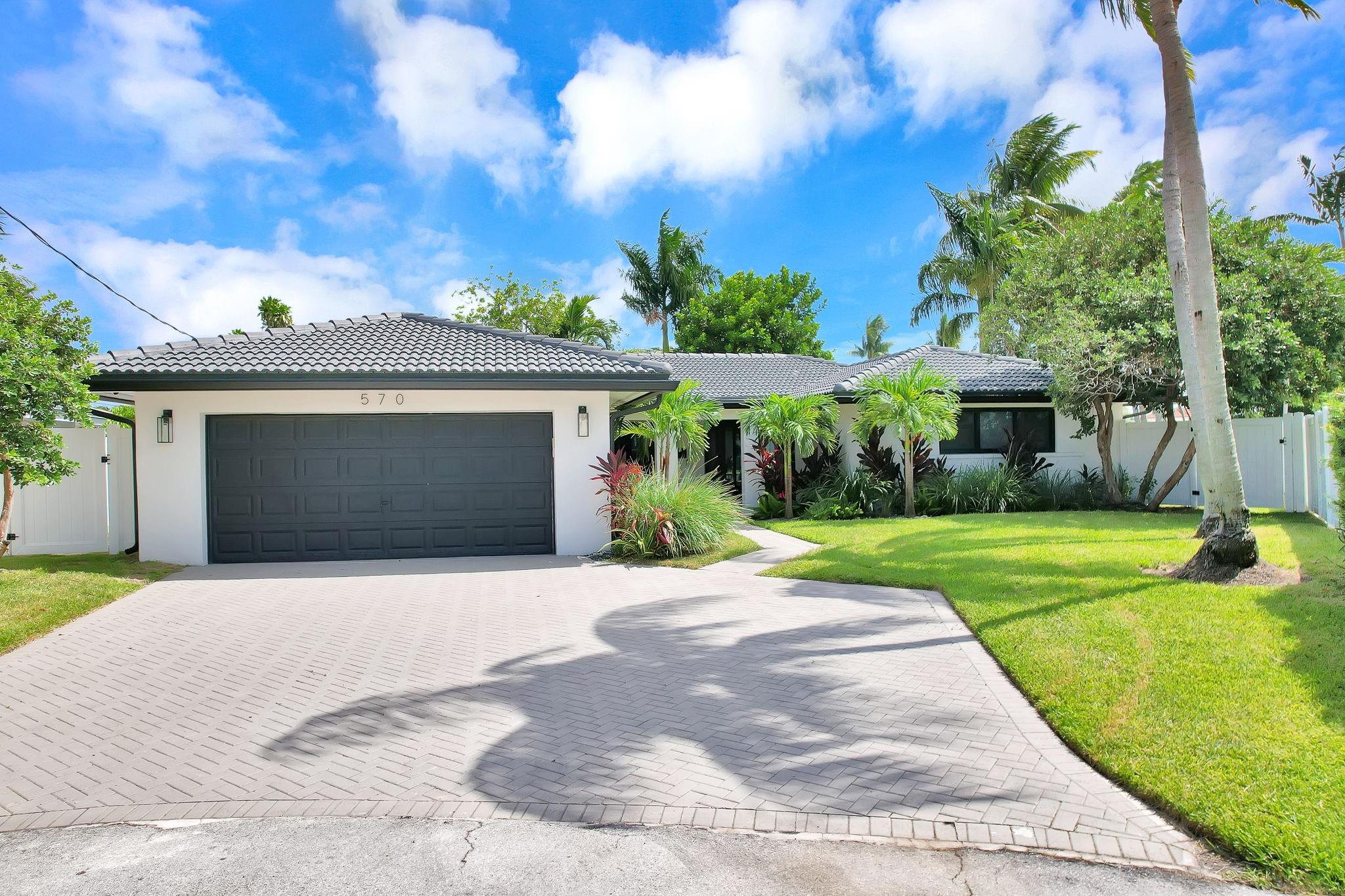 Welcome to your waterfront dream home in East Pompano Beach! Situated on a quiet cul-de-sac, this fully renovated 3-bedroom, 2-bath residence offers combined 150 feet of water frontage with direct ocean access and only one fixed bridge. The bright, open-concept layout seamlessly blends indoor and outdoor living, featuring a modern kitchen, impact windows and doors, and tile flooring throughout. Enjoy a resort-style backyard with a heated pool, expansive patio, and private dock. Currently operating as a licensed Air BNB- the opportunities are endless at this one of a kind waterfront residence.