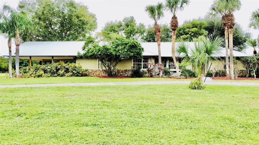 Located in the highly desirable SW section of Okeechobee, this spacious home boasts nearly  2,700 sq ft under air featuring 3 bedrooms, 3 bathrooms plus a bonus room that could serve as a 4th bedroom or office. The property also features a brand-new metal roof and carport, modern updated bathrooms, and plenty of room for animals with a horse barn, storage shed, and two fenced pastures. With city water and septic, plus a private well running the irrigation system, this home has all the modern comforts while keeping a quiet, peaceful setting. Just five minutes from the center of town, it’s the ideal place for family living, hobby farming, or simply enjoying the country lifestyle. Offering the perfect blend of country charm and convenience, this property may be perfect for you.
