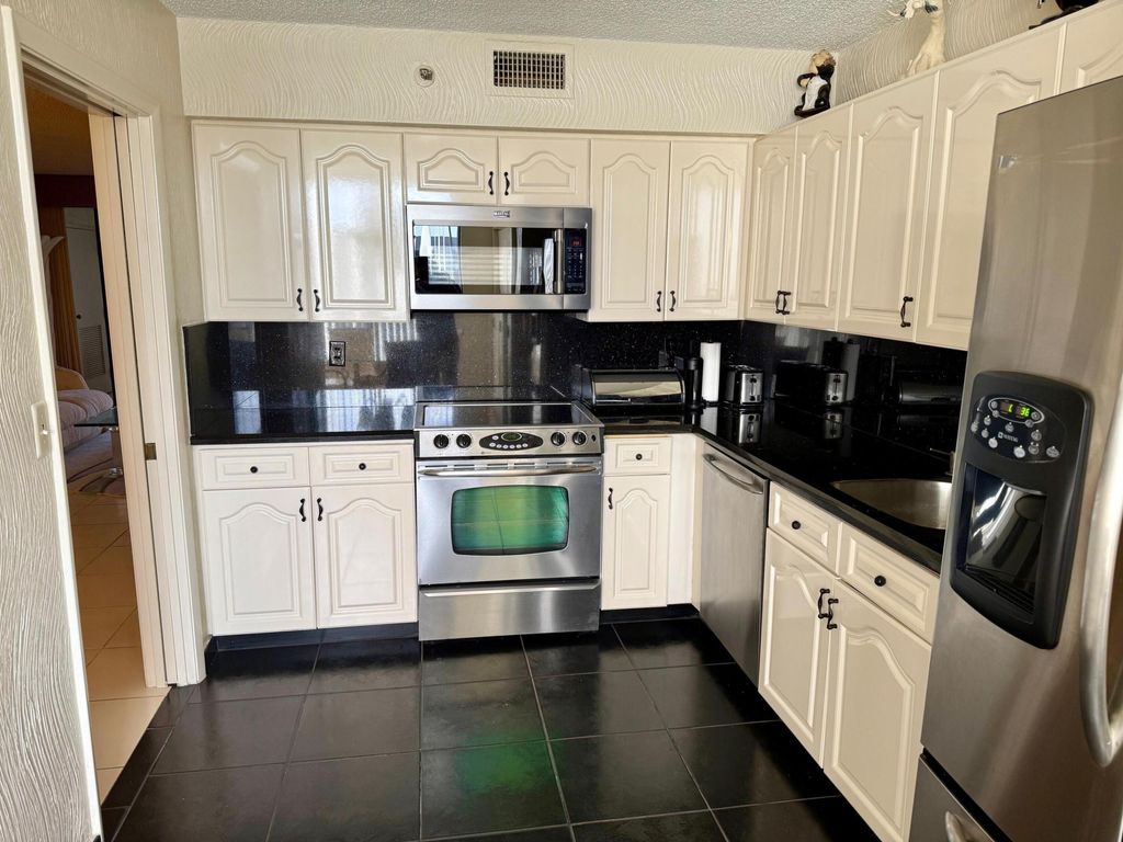 Photo of 7564 Regency Lake Drive #702, Boca Raton, FL 33433 (MLS # R11140044)