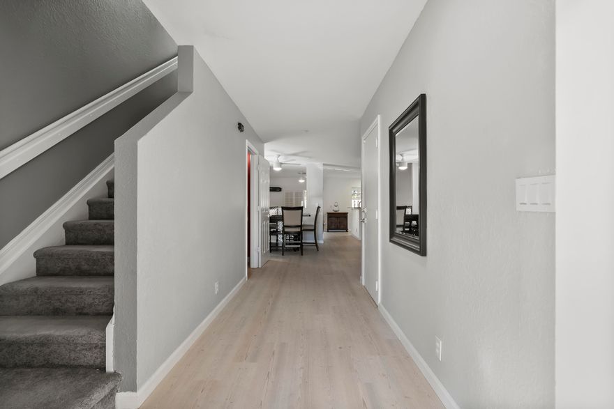 Spacious corner-unit townhome in Martin's Crossing offering flexible living space and modern updates in a prime Stuart location. The first floor features luxury vinyl tile flooring, smooth ceilings, and an open kitchen with tile backsplash and LG appliances, including an LG ThinQ refrigerator. Two separate living areas plus a dedicated dining space provide versatile layout options. A half bath and one-car garage complete the main level. Upstairs, a generous loft creates separation between the primary suite with large walk-in closet and two additional bedrooms. Stackable washer and dryer included. Convenient to I-95, Martin County High School, and Costco.