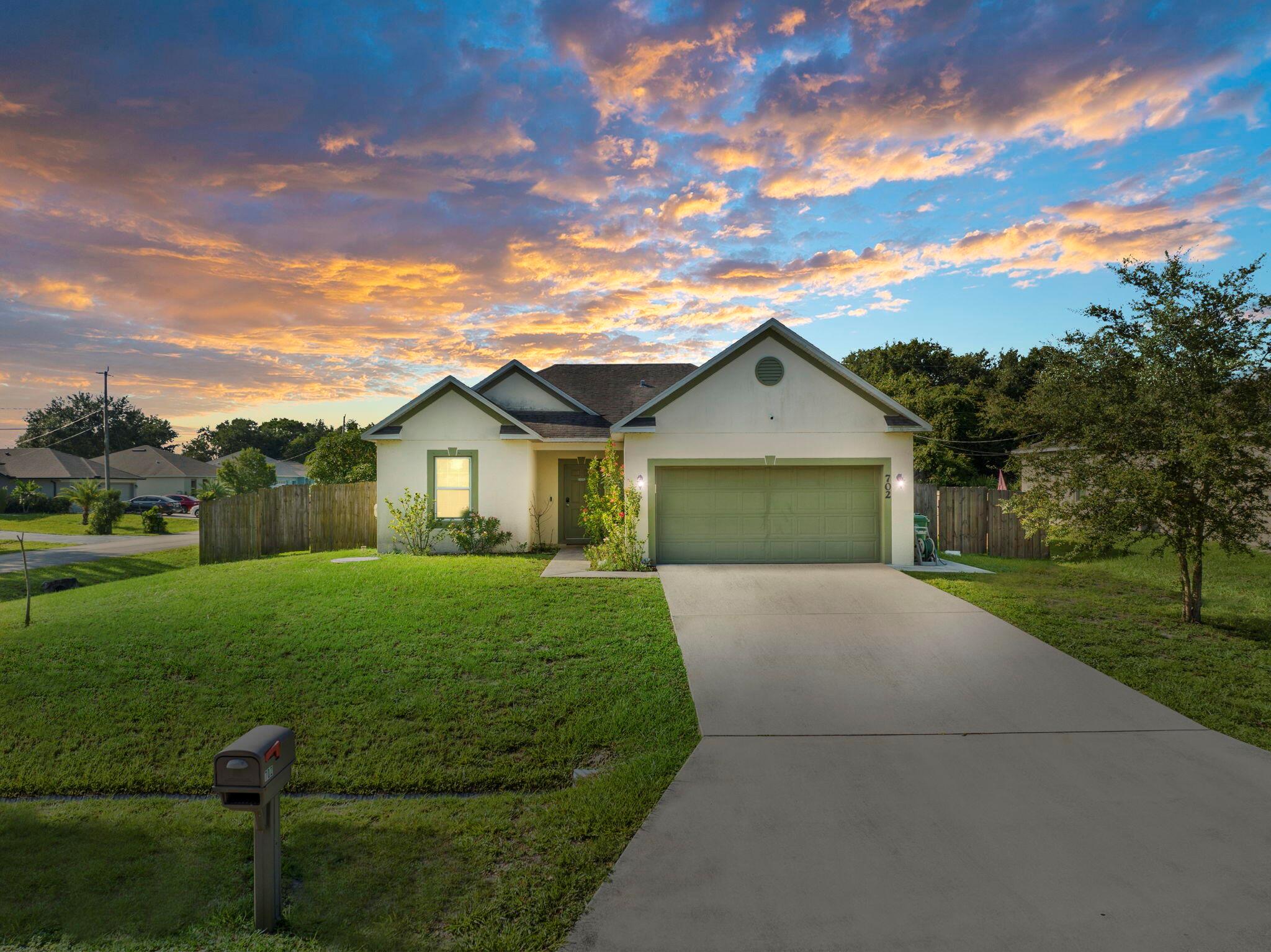 Welcome to this beautifully maintained 3BD/2BA home on a fully fenced oversized corner lot in a desirable area of Port St. Lucie! This move-in ready property features tile flooring throughout, an open-concept layout, and a spacious kitchen with rich wood cabinetry, stainless steel appliances, and an island perfect for entertaining. The split floor plan offers privacy, and the primary suite includes a dual vanity bath and walk-in shower. Enjoy indoor-outdoor living with sliding glass doors leading to a large backyard and patio--perfect for pets, gatherings, or adding a pool. Located near parks, schools, and easy highway access. No HOA!