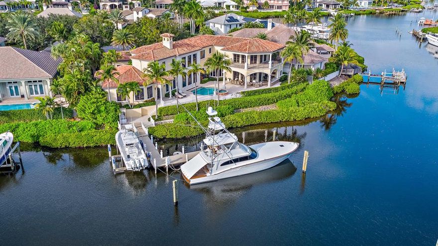 This Custom Waterfront Estate Home is truly a gem. With over 180' of water frontage all within minutes to the Intracoastal, the views are spectacular. Interior is newly painted, built-ins added... you can stop looking for a home. This home will not last and it has something for everyone. 4 bedrooms all with private full baths, 1st floor master bedroom, office, enormous club room with full service wet bar, large screen for viewing, and a wraparound balcony, large motor court, cul-de-sac location, light and bright kitchen and family room all with views of the pool, patio and waterways are a few of this homes treasures.