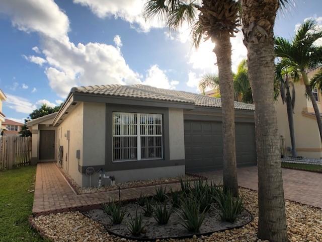 Why pay rent if you could own! Here's a nice single story 3-bedroom home. Going through the private entrance, it opens to an inviting living room/great room with tranquil garden view. There's no carpet in the house. Tile throughout living area. Laminate and tile floor in 3 bedrooms. Updated kitchen features new microwave which was replaced in 2019, and corian countertops. Ample kitchen cabinets have been refaced. Exterior was repainted 2 years ago. Large (16'x15') covered and screen patio provides a great place to relax or have table games with the family. Fenced backyard is the paradise for garden lovers. There're plenty fruit trees and herb plants, such as Star Fruit, Lychee, Lemongrass, Aloe to name a few. Nautica Sound is a gated community. The club house features resort style