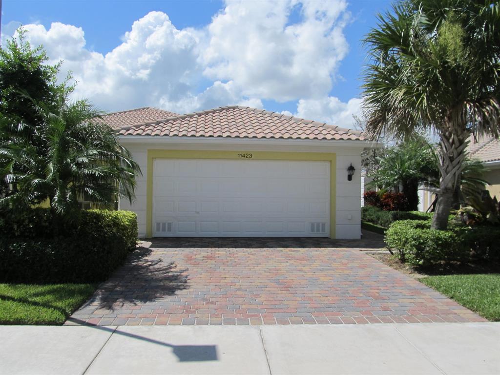 Furnished waterfront villa in Lakes at Tradition. Peaceful lake views from your private screened lanai with extended paver patio. Open floor plan has custom built media storage with fireplace, wood beamed ceilings, wainscoting and chair rails. Plantation shutters & woven door blinds. Porcelain tile and wood laminate flooring in living areas, new carpets in split bedrooms. Kitchen has Corian counters, natural stone back splash, upgraded dishwasher & microwave. Master bath upgraded with tiled shower, frameless glass, wainscoting, and framed mirrors in both baths. This home has central vacuum system and inside laundry room with Corian & deep sink. Rent includes basic cable, internet, lawn maintenance, and community amenities include: manned gate, 2 heated pools, tennis, basketball, pickleball