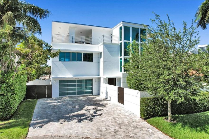 Stunning 3-story modern design home with quality construction & finishes,Granite walls,Custom Wenge woodwork,Vantage lighting, One off the point on a cul-de-sac, walk to beach. 80 ft concrete dock w/space to enjoy Canal & Intercoastal views,60 Foot Heated Salt Water Lap PoolLevel 1.Gated courtyard leads to impressive Mahogany front door, Open living room-dining area surrounded by 400 bottle wine wall,10 foot sliding glass walls open to the water, Chefs kitchen, pantry,2nd Master & Full bedroom, Elevator & glass enclosed staircase Level 2.Luxurious master/spa bath, dual water closets, steam shower, soaker tub,3 additional en-suite guest bedrooms. Laundry room, Professionally gym Level 3.Suite w/kitchenette,full bath. Covered area w/relaxed seating areas & 360 degree views Level 1.Enter the gated front courtyard through the impressive Mahogany front door and find yourself admiring water views through dramatic open living and entertaining areas. 10 foot sliding glass walls. Expensive ultimate chefs kitchen with large walk-in pantry. The Open living room/great room flows to the dining area surrounded by 400 bottle wine wall showcase and state of the art wine cabinet and buffet wall. Secondary Master/ VIP suite and an additional bedroom suite. Elevator and glass enclosed staircase. Full width covered porch with summer kitchen and custom automated Phantom screen enclosure. 60 x 15 salt water heated lap pool with built-in Jacuzzi feature.Level 2.Ultra luxurious master suite and spa style bathroom with dual water closets, steam shower and soaker tub with onyx back wall w/covered balcony.  Three additional en-suite guest bedrooms. Laundry room. Professionally outfitted commercial grade gym. Level 3.Bedroom suite with kitchenette and full bath. Walk out to the incredible top floor covered expansive area with relaxed seating areas, ping pong table & wonderful 360 degree views.