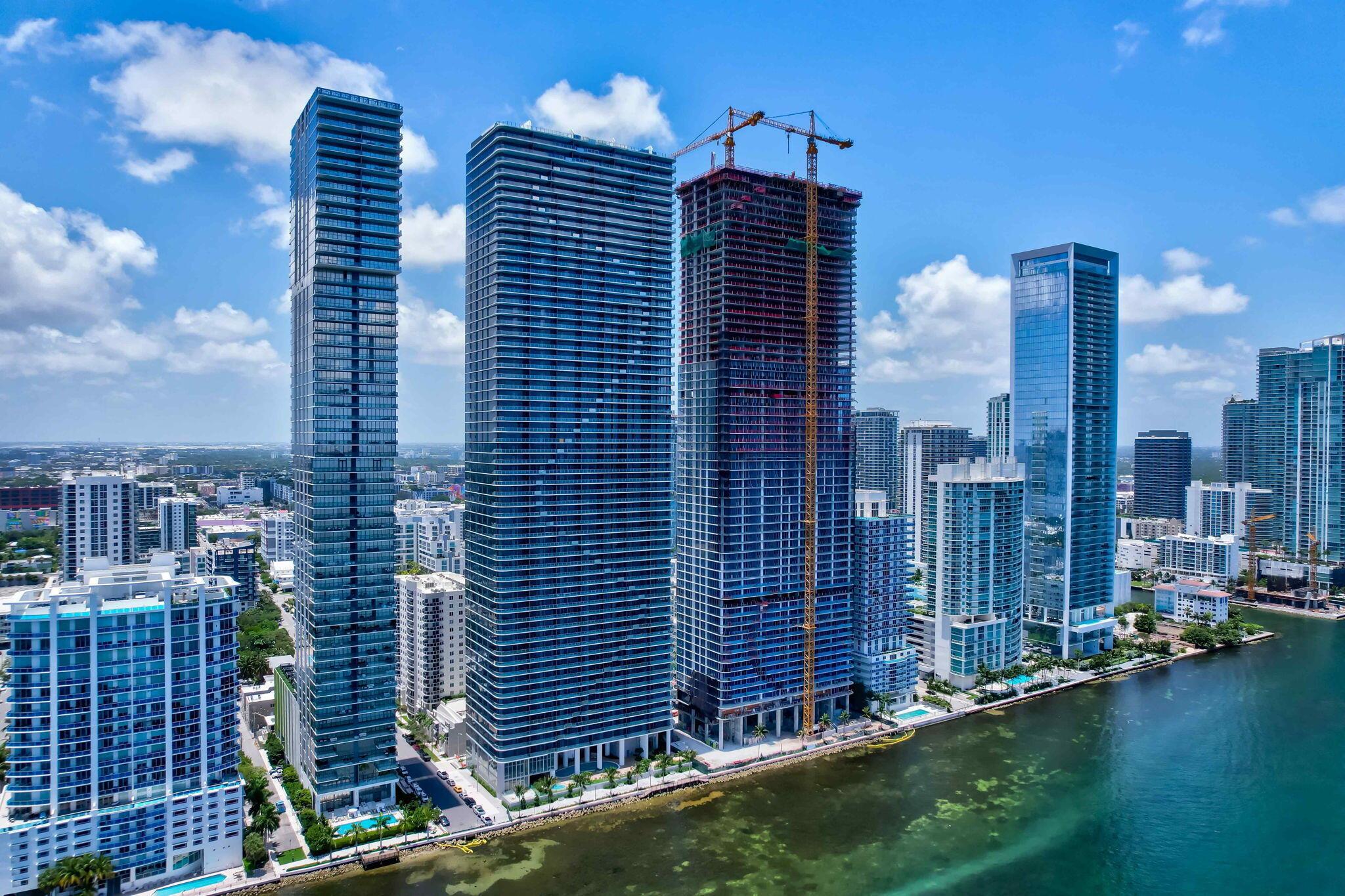 Be the first to experience luxury living in this brand-new, never-lived-in corner residence at the highly anticipated Aria Reserve. This expansive home in the sky offers the ultimate blank canvas, allowing you to craft your personal vision against the backdrop of breathtaking views. Perched high above Biscayne Bay, this residence features floor-to-ceiling impact glass throughout, flooding the space with natural light and framing panoramic vistas of the bay, Miami skyline, and the Atlantic Ocean.With an open-concept layout and a sleek gourmet kitchen, this home is perfectly designed for both intimate relaxation and stylish entertaining. Each spacious bedroom includes its own en-suite bathroom, providing comfort, privacy, and sophistication at every turn. This model includes a den.