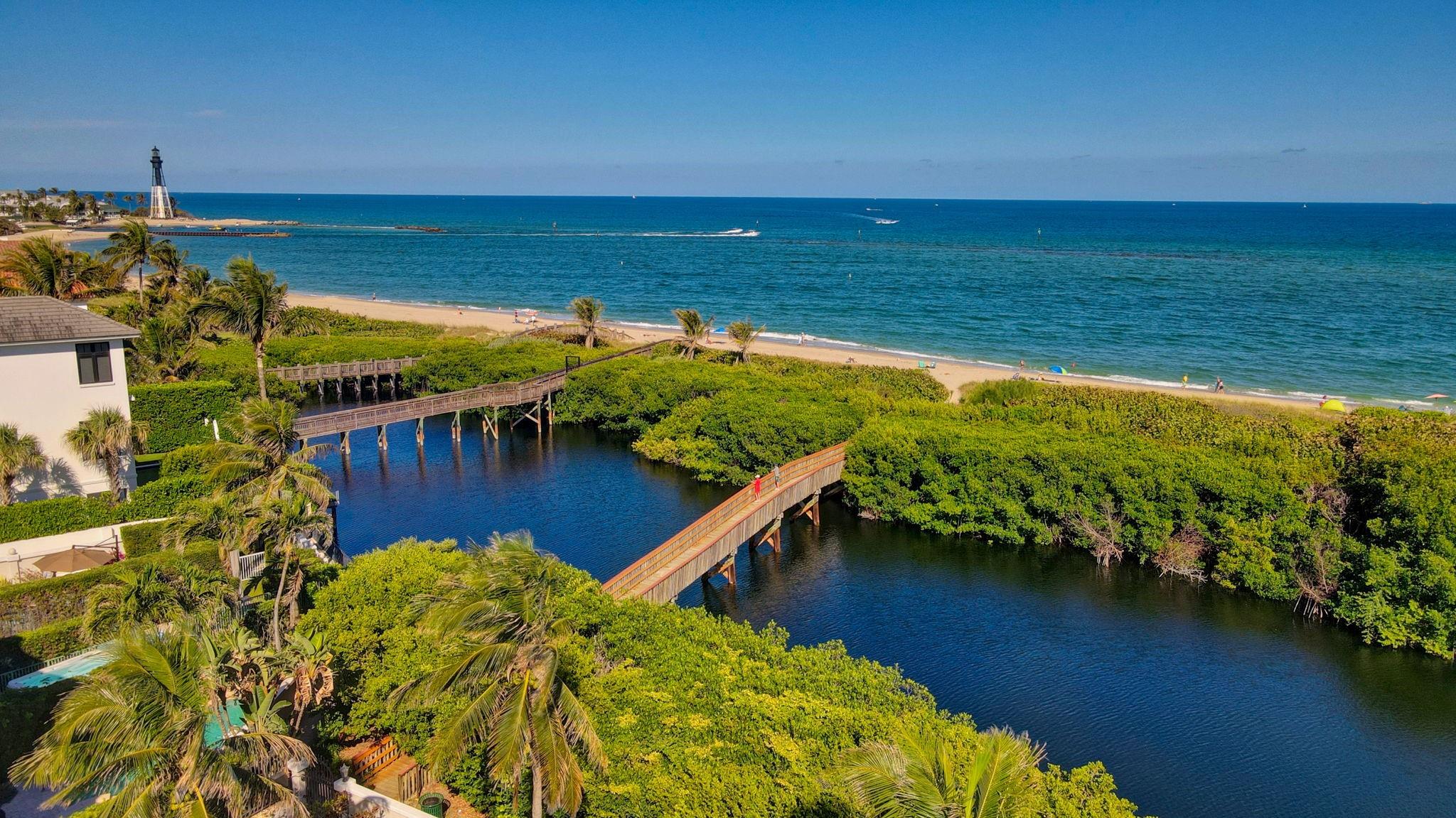 Welcome to your seaside oasis. Located in the boutique gated community of Hillsboro Bay By the Sea. This updated luxury townhouse boasts numerous amenities to include hurricane protection, private elevator, 2 car garage/driveway, renovated luxury kitchen with convection cooktop, wolf and subzero appliances additional wine refrigerator, 1st floor Great room- with built-in bar, refrigerator, wine cooler, microwave & dishwasher & a private jacuzzi nestled in a tropical garden. 3 bedrooms 3 1/2 baths allows the space of a single family home without the worry of exterior maintenance. Private gated access to Pompano Beach. This community is an HOA (not subject to the new condo regulations) Maintenance fees include landscaping, exterior maintenance, flood & hazard insurance.