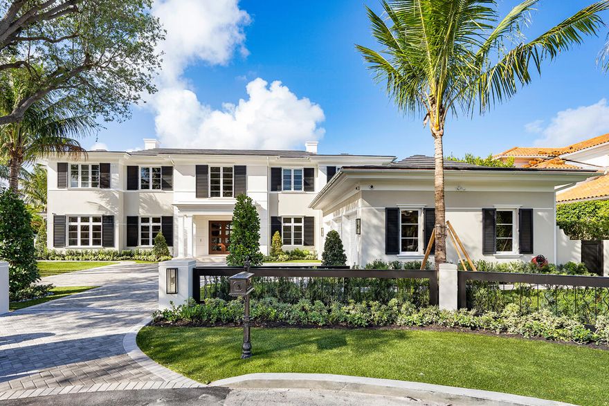 Set along 158 feet of the Butterfly Palm Waterway, 133 Coconut Palm Road is a waterfront estate by Wietsma Lippolis Construction, quietly positioned within Royal Palm Yacht & Country Club. Spanning over 8,400 square feet, the residence unfolds through a grand, open layout designed for both scale and ease of living. The main level transitions seamlessly from formal living and dining spaces to a well-appointed gourmet kitchen and family room, complemented by a club room with bar and wine cellar, a private library, and a flexible guest suite or fitness space. Upstairs, a secondary living area creates a natural sense of separation, accompanied by four en-suite bedrooms and a private primary suite with dual baths and dressing rooms, all oriented to capture calm, uninterrupted water views. Outdoors, a series of covered and open-air spaces frame the waterfront setting, where a summer kitchen, fire feature, and resort-style pool with spa are positioned to take full advantage of the home's expansive frontage. Originally constructed with a high level of finish and specification, the home presents a rare opportunity to secure scale, quality, and a refined waterfront lifestyle within one of the community's most established settings.