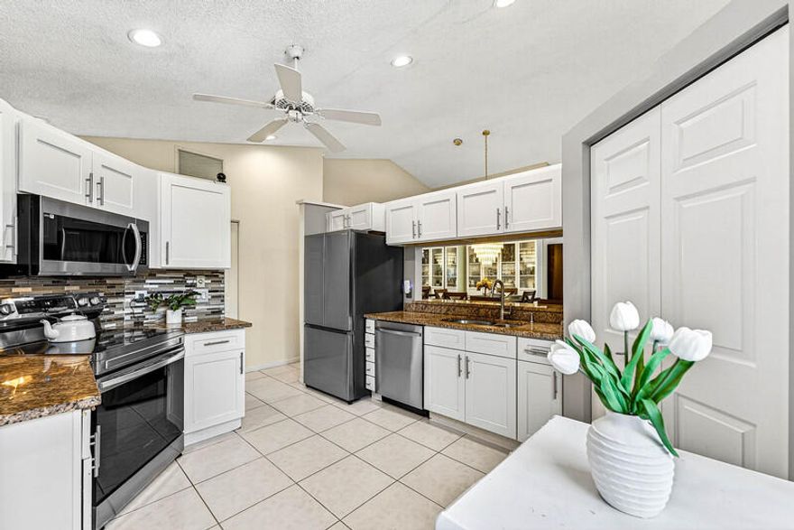 Welcome home to your beautiful new villa in Lexington Club of Delray Beach. This light & bright single story villa features two full bedrooms & bathrooms, an updated kitchen w/ white shaker cabinets, granite countertops, & stainless steel appliances, updated bathrooms, tile & vinyl flooring throughout, accordion hurricane protection, & a glass enclosed patio area w/ access from both the living room & primary bedroom. Lots of storage& closet space throughout, full size washer & dryer, & a lovely garden view from the patio. Lexington Club is a premier 55+  gated community w/ a beautiful clubhouse w/ community room, pool, hot tub, pickle ball, tennis, fitness center, shuffleboard, waling path, & the list goes on. Fabulous location close to shops, Downtown Delray, & places of worship.