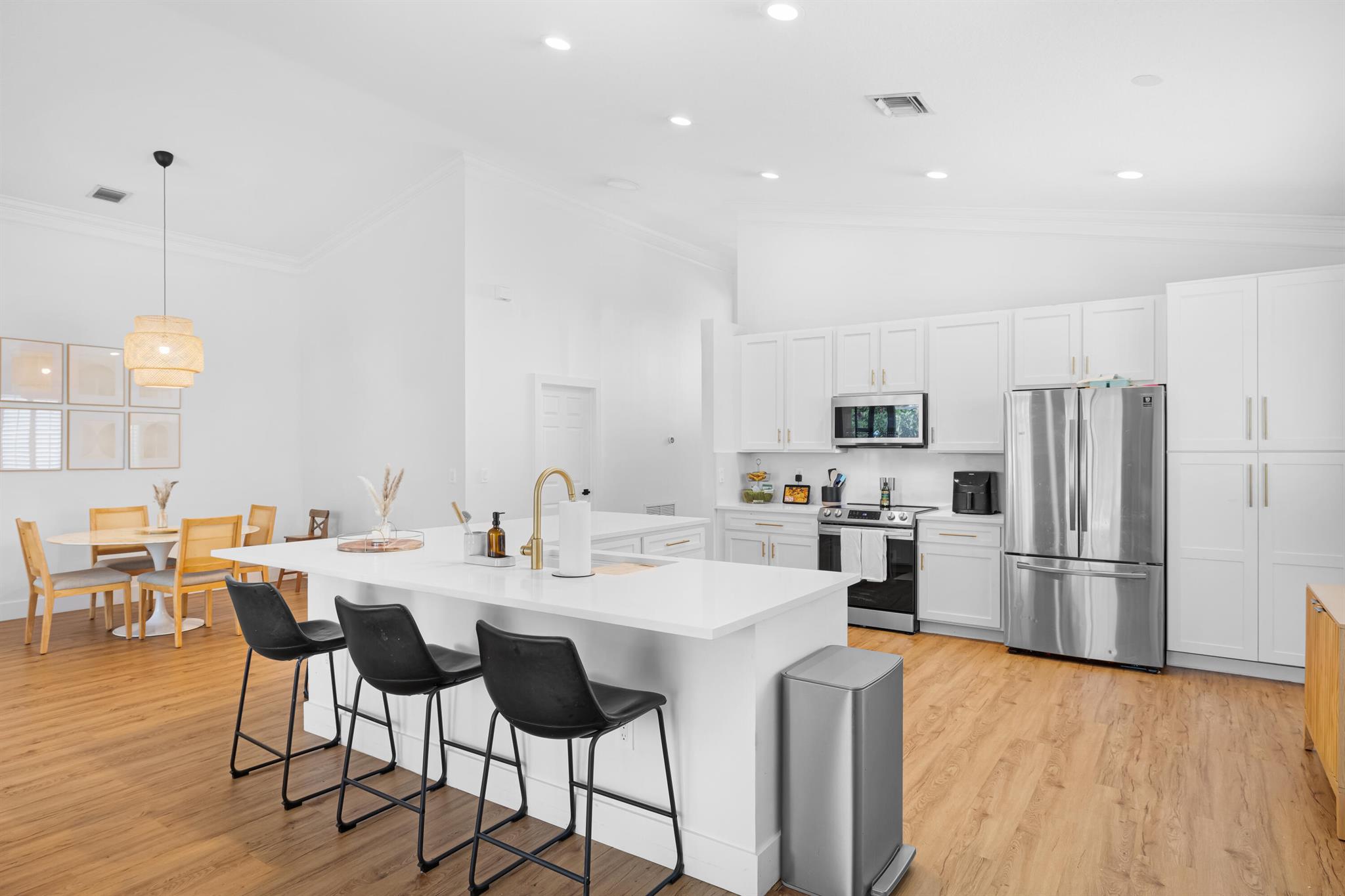 Check out one of the rarely available fully remodeled 3 bed 2 bath single story home in the community of Andros Isle. This CBS home features an open concept living and split floor plan. The kitchen features white cabinetry, quartz counters, and newer stainless steel appliances. Vinyl plank flooring runs seamlessly throughout the home. The primary bedroom has two custom built walk in closets. Impact windows and shutters provide complete protection from storms. The 2 stall garage features a FPL EV Charger. Enjoy the screened in patio recently screened with a special no- see-em screening with views of the 23 mile grassy waters preserve. This home is located close to shops and dining such as Target, Starbucks, Bimini Twist and more.