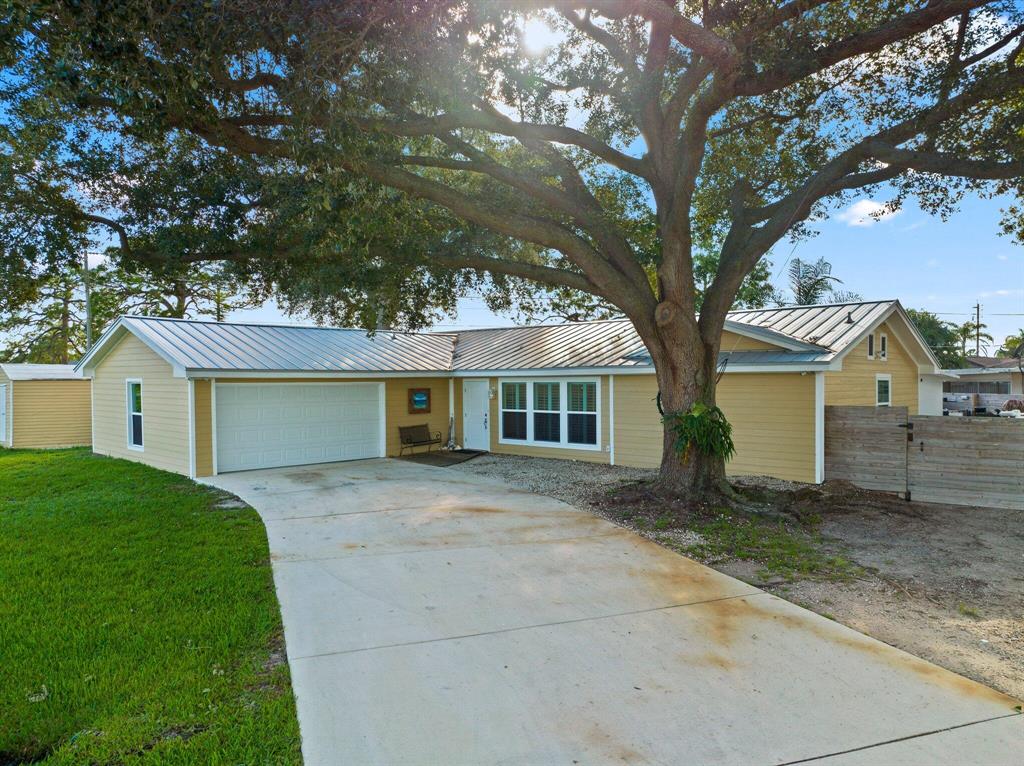 You will love this fully remodeled home located in the Crosstown Parkway area of Port St Lucie. Dont waste time and money on a fixer upper. No stone was left unturned in this complete remodel. This 3-bedroom, 2 bathroom home has a 2-car garage and 1,697 sqft of spacious elegance. Recent upgrades include new plumbing, electrical, A/C ducts and returns, fixtures, luxury vinyl floors, instant hot water heater, plantation shutters, bathrooms, kitchen, Florida room, and more. Exterior upgrades include a 2019 Metal Roof, 2022 Hardie Board Siding, and 2022 Impact Windows/ Doors. Peace of mind for decades to come! Plus reduced energy & insurance bills! The expansive backyard is made up of 3 sections - The North section is separated by a rolling gate/fence & is perfect for securing a small boat/RV