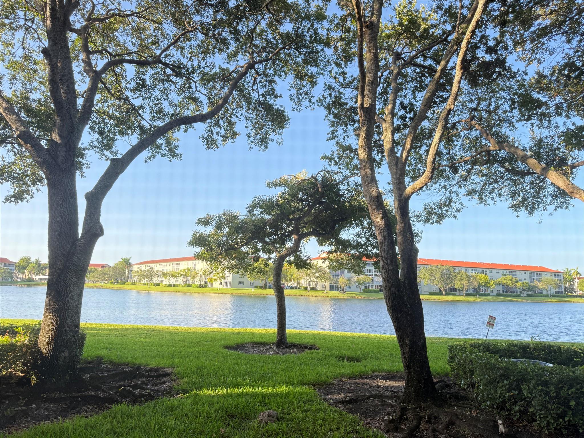 Discover this charming and spacious ground-floor Nandina model with serene lake views, ideally located just steps from the mailboxes, the community pool, and the back gate of Pembroke Pines, with your assigned parking space right in front and plenty of guest parking. This unit is perfect for a single person, a couple or investor, offering a blank canvas to make it your own and add your personal style. Located in a desirable 55+ community with no rental restrictions, it’s an excellent opportunity for full-time living or income potential. Residents enjoy a wide range of amenities including multiple pools, a clubhouse, movie theater, billiards, scheduled movies, security patrols, and transportation services, making this a vibrant and convenient place to call home.