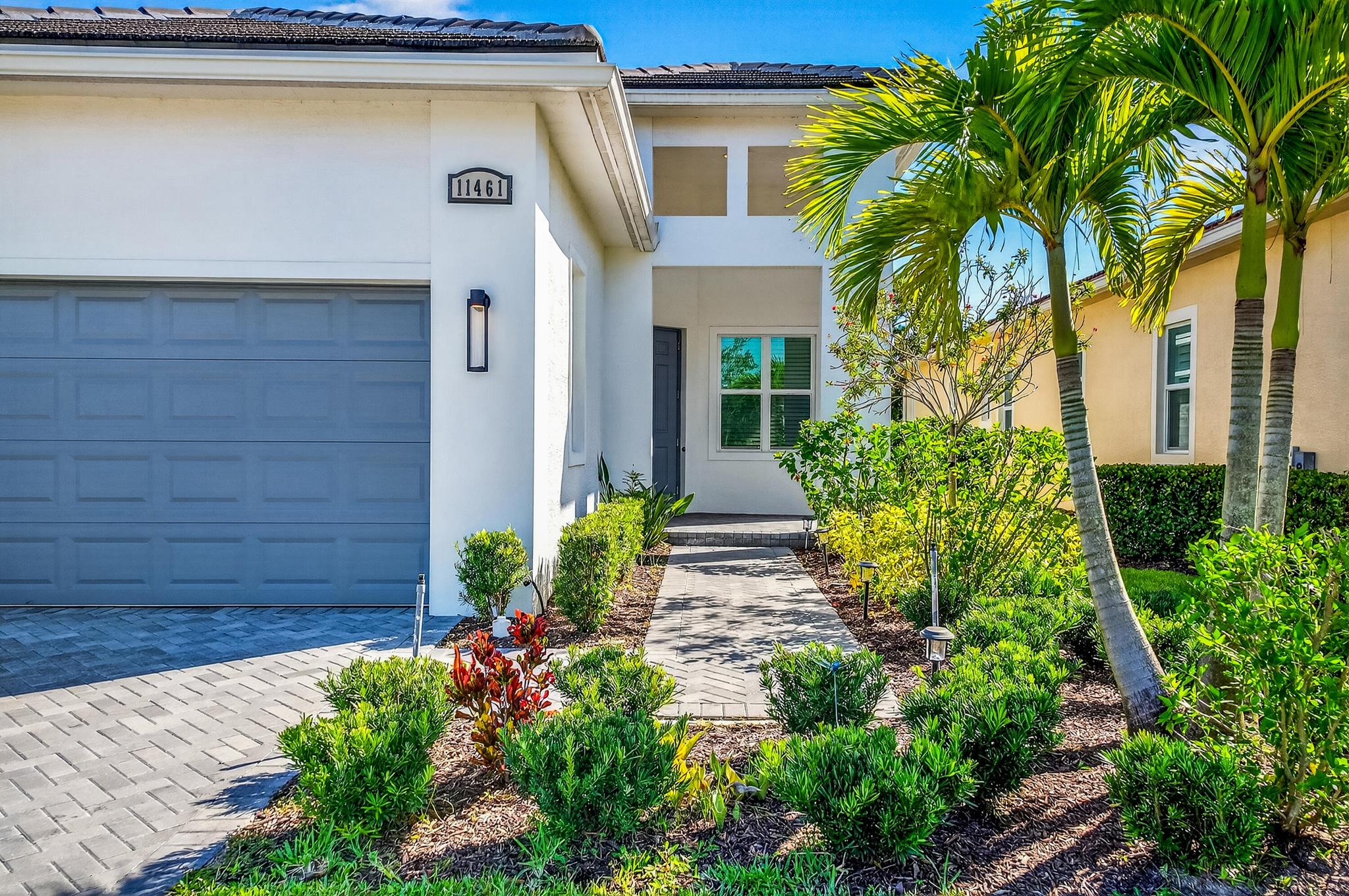 Welcome to an exquisite opportunity at 11461 Southwest Visconti Way, nestled in the prestigious PGA Verano located in Village Emilia community in Port St. Lucie, Florida. This sophisticated single-family home, constructed in 2022, offers a seamless blend of modern elegance and functional living across 1,646 square feet.The spacious living areas feature tile flooring, complemented by plush carpeting in the bedrooms. Tray ceilings elevate the aesthetic in both the living room and the master suite, which also boasts dual closets and a walk-in shower.The gourmet kitchen is a culinary enthusiast's dream, equipped with stainless steel appliances, granite countertops, designer tiled backsplash and 42-inch cabinetry. Enjoy serene lake views from the lovely eat in kitchen.