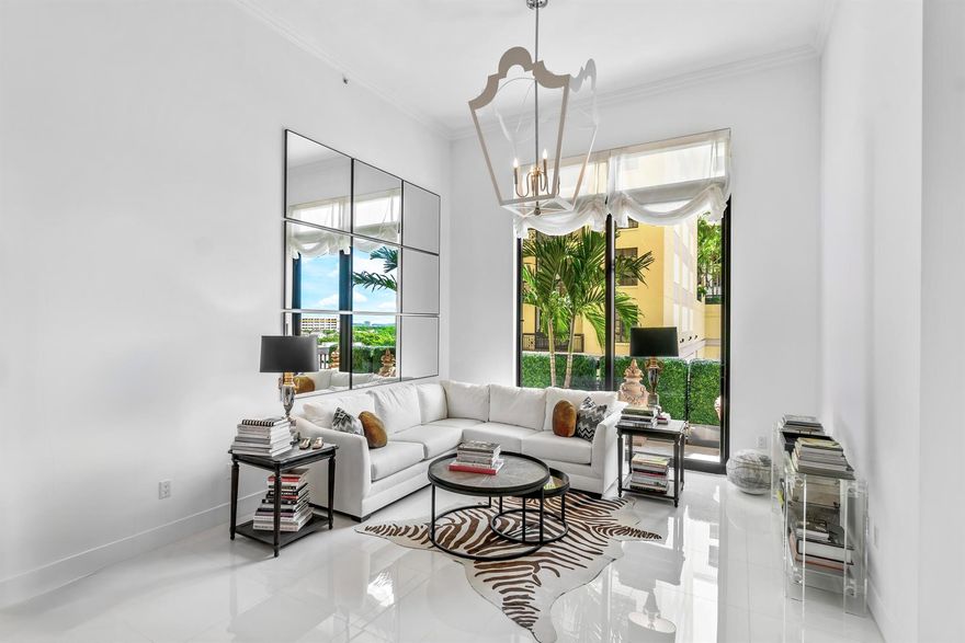 In the heart of downtown West Palm Beach, you'll find a stunning fully renovated condo that exudes modern luxury. This spacious residence boasts two generously sized bedrooms each with its own private bathroom, and a versatile den that can serve as a home office or additional living space. With soaring 14-foot ceilings, this condo offers an open and airy atmosphere that's truly captivating. Enter into the heart of this home, the designer kitchen, where no expense was spared. It features all new appliances, exquisite countertops with oversized waterfall island and custom cabinetry, making it a chef's dream come true. The entire condo showcases all-new flooring that adds elegance to the space. Designer lighting, window treatments and molding add the final touches to truly make it special...