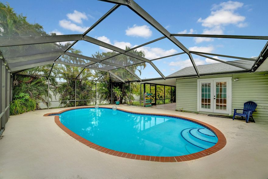 VERY MOTIVATED - The search is over - come fall in LOVE with this 3 bedrooms, 2 bathrooms, flex room and HUGE Florida room with french doors leading to the covered screened in patio with a pool! UPGRADES include: 2024 roof (transferable warranty), impact windows, open kitchen with granite counter tops, pool pump, and updated bathrooms. Sellers are offering credits. The home is centrally located in Port St. Lucie close to the Florida Turnpike, beaches, Pioneer Park, beaches and so much more!