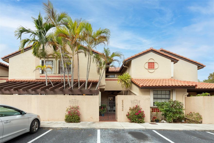 Welcome to this charming 2/2.5 townhome in the Courtyards at the Crossings.  Open the gates to a cozy patio which leads you into the bright townhome full of windows and space.  The 1st floor is tiled throught, the kitchen has an eat-in counter, stackable washer/dryer and plenty of space to prep, 1/2 bath for your guest, and very useful storage space under the stairs.  Both primary rooms have an ensuite bathroom,  vaulted ceilings, 1 room has a walk-in closet the other a large closet and sliding doors to access the functional shared balcony.  Accordian shutters throughout, A/C 2019, roof 2022, no assessments, community pool, tennis, pickleball, basketball, and event room. The Courtyards is tucked away from traffic but close enough to walk to a shopping plaza w/everything you need.