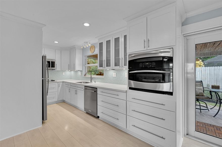 BRING YOUR FHA AND VA BUYERS. This 3/2 Completely renovated home is located in a desirable neighborhood, this impeccably maintained home offers a fantastic opportunity for homeowners or investors. Featuring a 2014 metal roof, 2019 water heater, and 2024 A/C, the home is both energy-efficient and move-in ready. Inside, enjoy luxury vinyl flooring throughout and a stunning brand-new kitchen with sleek finishes and SS appliances. A stylish laundry room adds convenience, while the inviting yard features a relaxing hot tub—perfect for entertaining. FULL  IMPACT  windows offer added security and efficiency. Ideal as a primary residence, rental, or Airbnb, this home is the perfect mix of comfort, style, and investment potential. NO HOA. Great for FHA or VA loans. EV Ready!