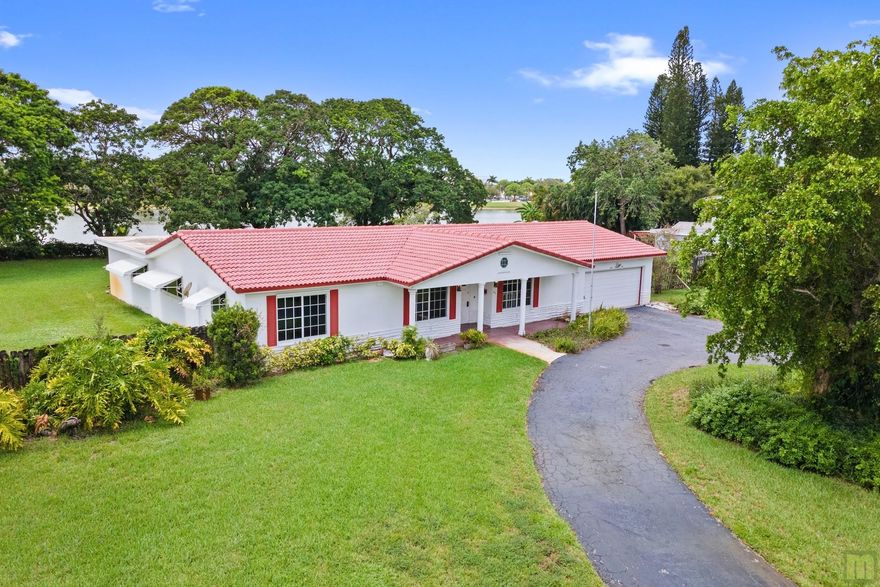 APPRAISED AT 850k. Rarely available Palm Beach Farms section of South Creek with NO HOA. This sprawling 4/3 lake front pool home sits on over an half acre of land. IMPACT windows and shutters for doors. Formal living, dining, family room, generous bedrooms, walk-in closets and HUGE screened / covered patio overlooking the pool and lake. Primary bath and 1 guest bath have access to the patio and pool, 3rd full bath is off the family room. Great neighborhood, close to schools, shopping, walking distance to Windmill Park and the Coconut Creek Community Center, a short drive to The Coconut Creek Promenade, and just 7 miles to the beach. Room measurements in pictures with the floor layout and a 360 virtual tour link.  So much house and so much land - come and make this your dream home!!