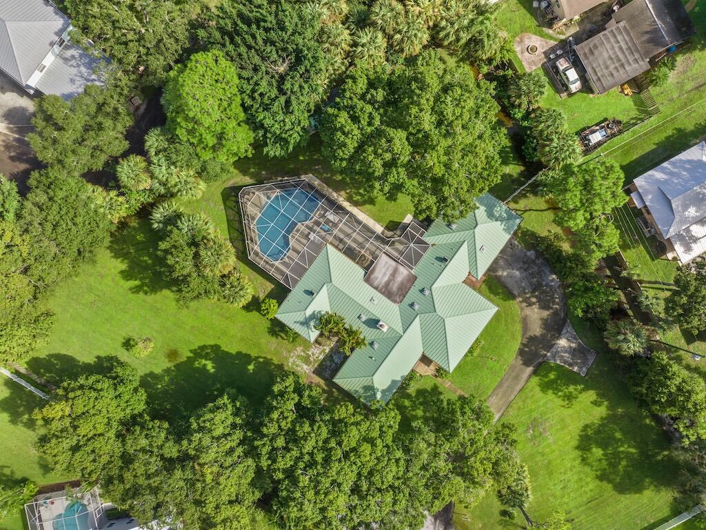 Welcome to your private Vero Beach sanctuary, a beautifully updated 3-bedroom, 2.5-bath with a bonus room residence is set on 1.16 lush, landscaped acres with no HOA. Designed for refined Florida living, this home blends timeless comfort with modern elegance. Enjoy peace of mind with a newer metal roof, impact windows, full re pipe, tankless water heater, and all new appliances. Inside, sleek plank flooring flows through bright, open spaces anchored by a cozy wood burning fireplace. The kitchen opens to a glass enclosed Florida room overlooking a resurfaced saltwater pool framed by tropical greenery. With unmatched privacy, high end craftsmanship, and resort style outdoor living, this home embodies luxury, tranquility, and the best of Vero Beach​​‌​​​​‌​‌​​​‌‌​​​‌‌‌​​‌​​‌‌​​​​ living.