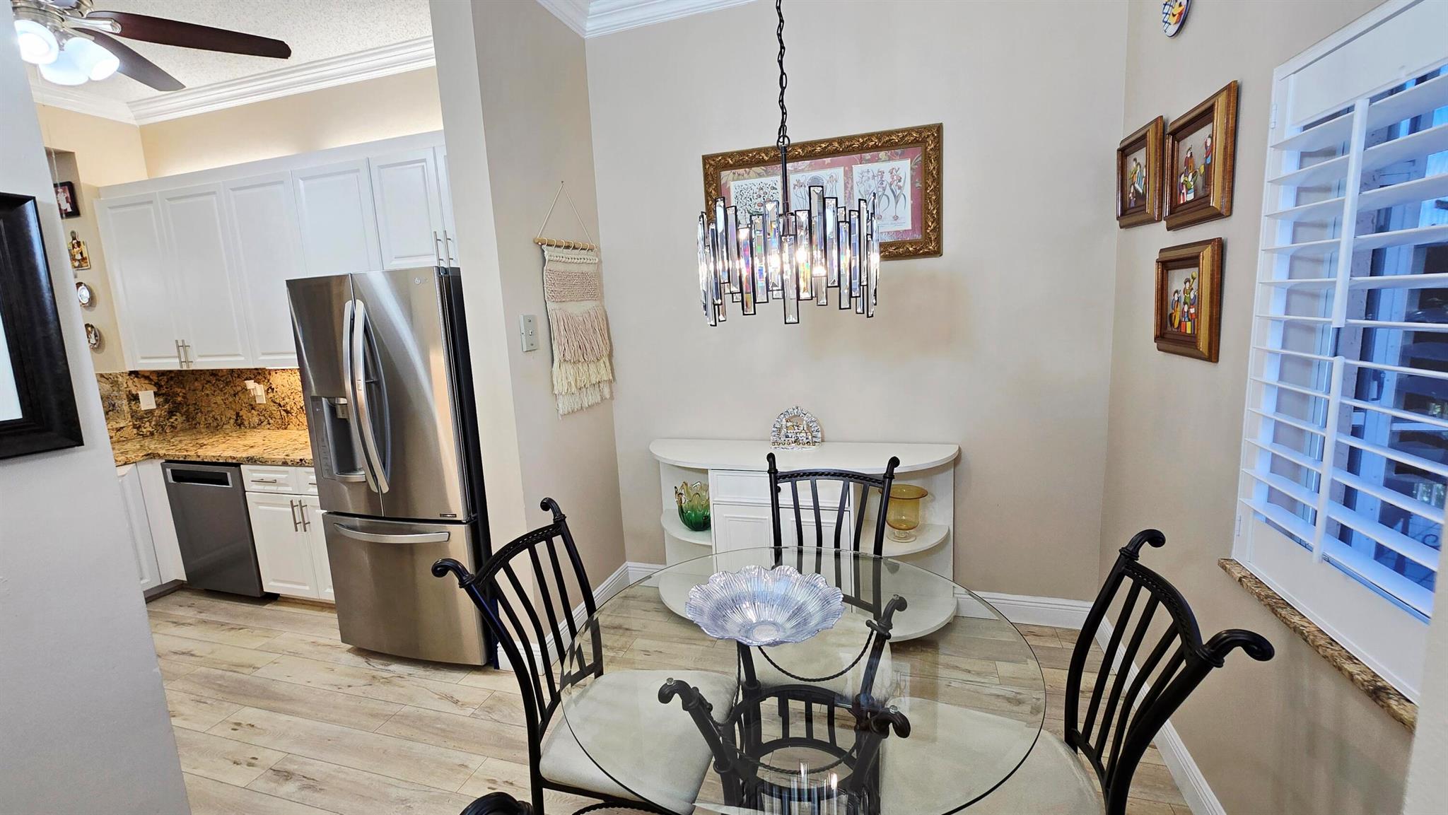 Welcome to your Florida dream Condo! This beautifully maintained 2-bedroom, 2-bath with 10 foot tall ceilings with crown molding, laminate floors throughout, located in the highly sought-after Weldon community within Kings Point, a premier 55+ gated neighborhood in Tamarac. Inside, you'll find an immaculate open layout with a split-bedroom floor plan that offers both comfort and privacy. The spacious primary suite features a huge walk-in closet and plenty of natural light. The main living areas are finished with elegant laminate floors for a clean, modern touch. The open-concept kitchen features white cabinetry with granite counter tops and overlooks the combined living and dining area, making it ideal for everyday living or hosting. A washer and dryer are also included for your convenien