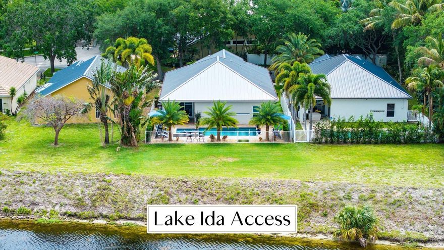 This may be the cleanest home on the market in Delray Beach. Set on a special lot in gated Delray Lakes, this updated 3-bedroom, 2-bath residence offers rare water frontage, direct access to Lake Ida, and no rear neighbors, a combination that is incredibly hard to find in East Delray. Tucked on a cul-de-sac in Delray Lakes, one of East Delray's best kept secrets, this home offers privacy, peace of mind, and just minutes from Downtown Delray Beach. Furnished optional. Inside, the home has been beautifully updated and maintained at an extremely high level. The kitchen has been fully remodeled with clean, modern finishes and induction cooking, while other major improvements include a metal roof, updated A/C, water heater, smart electric panel, and full impact windows and doors throughout. Every inch of the home reflects pride of ownership, and the level of care here is immediately obvious. Even the garage stands out, with epoxy floors and an overhead storage system so clean and well thought out that the space could easily serve as more than just storage. The backyard is built for easy South Florida living, with a heated saltwater pool, resurfaced finish, extended pool deck, new pump, smart pool controls, and a fully fenced yard that feels private and calm. An extended paver driveway adds to the home's polished exterior appeal. Rarely does a home offer this level of condition, privacy, water frontage, and future boating potential within a gated community in East Delray.