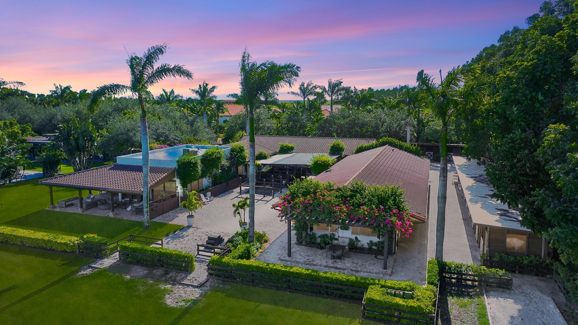 Welcome to Eye Candy Jumpers, a premier equestrian estate where world-class sport and refined luxury unite. Situated in the heart of Wellington, this distinguished haven is home to one of the most recognized names in international Show Jumping, celebrated for producing top competitors and excelling on the global stage.Designed with the serious rider in mind, the estate features a gorgeous irrigated arena with premium GGT footing and 7 acre derby field, ensuring peak performance conditions. The stables currently feature 10 impeccably maintained stalls, while expansive grass fields and expertly designed paddocks create an ideal environment for both training and relaxation.