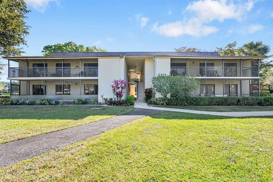 This second-floor unit in Hidden Woods of Deer Creek is a prime opportunity to live year round or rent annually or monthly.  Located near non-mandatory membership 18-hole golf course & minutes from Deerfield Beach, the condo features large tiles, a cozy kitchen w/ wood cabinetry & a standout 31-foot screened patio w/ large storage room. Big closets & W/D hookup in unit.  Premium views of green area/pool from balcony & golf course view from master. Cable, internet, & insurance included plus amenities including a pool and clubhouse. Pet friendly, quaint community with only 8 units per building offers a low-maintenance lifestyle, but highly accessible location close to shopping, major highways. Walk to Golf Course w/pro shop, restaurant & bar  One parking spot assigned plus guest parking.
