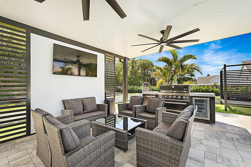 SPECIALTY PROPERTY! ONE-OF-A-KIND POOL HOME on a spacious 1.7-acre lot offers the perfect blend of indoor comfort and outdoor living. This 3-bedroom, 2-bathroom home features a 2024 roof, impact windows and doors, and an open-concept layout with vaulted ceilings. The modern kitchen includes quartz waterfall countertops, updated appliances, ample cabinetry, and recessed lighting. Both bathrooms have been tastefully updated with contemporary finishes. Step outside to a private oasis with a heated saltwater pool (2021), expansive pool deck, and designated entertainment area. There is an attached 2-car garage PLUS there is a detached 3-car garage ideal for boats, RVs, motorcycles, more storage and flex space. The extra poured concrete extends the driveway throughout the property. So MUCH MORE