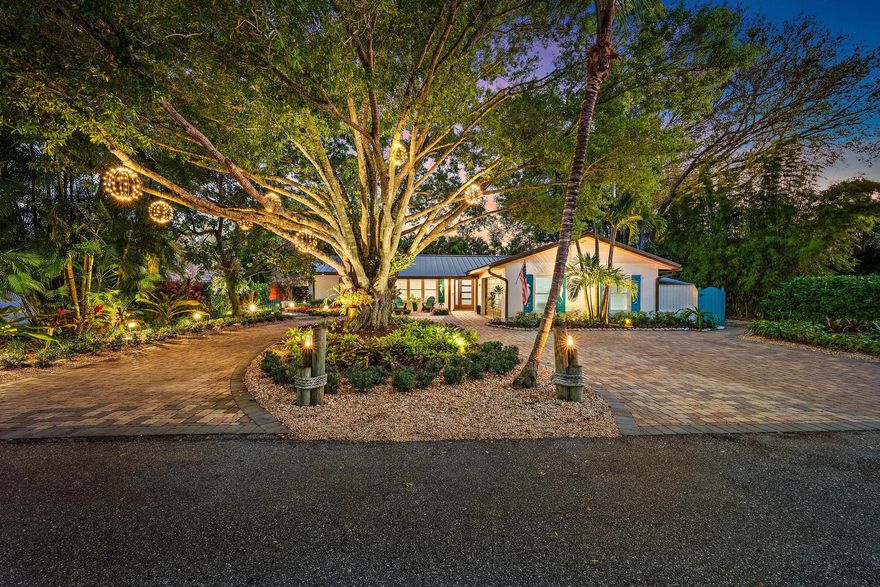 This exceptional residence is a true hidden gem, capturing the charm of old Jupiter and the essence of refined Florida living. Yacht Club Estates is ideally tucked just behind the iconic Dune Dog Café. The home was completely renovated with quality craftsmanship and offers three bedrooms, two baths and thoughtfully designed living spaces both inside and out.  Inside, the home welcomes you with a bright and open layout highlighted by wood porcelain flooring throughout, elegant crown molding, and classic plantation shutters that add timeless character. The newly updated kitchen showcases quartz countertops, highlighted by a striking 2.5-inch mitered edge on the island, white cabinetry, and stainless-steel Bosch appliances, including an induction cooktop. A spacious snack bar completes the space, making it perfect for casual dining and effortless entertaining. Designed with both style and functionality in mind, the kitchen flows seamlessly into the dining and living areas, creating an open and inviting space ideal for everyday living and gatherings.  The luxurious primary suite serves as a private retreat, complete with a walk-in closet, and a spa-inspired bathroom featuring a large glass-enclosed shower with floor-to-ceiling tile. Notable features include ship lap accent walls, laundry cabinets with pull outs and tons of storage, French drains surrounding the property, amazing, lush landscaping with lighting, a new standing seam metal roof, and newer hurricane-impact windows throughout the home provide added security and peace of mind.  Step outside to your own private backyard oasis, where lush landscaping surrounds a resort-style setting designed for relaxation and entertaining. A spacious covered and screened lanai with a tongue-and-groove ceiling (featuring new screening) opens to beautifully paved decking and a brand-new private pool and spa with a waterfall—creating the perfect setting to enjoy Florida's year-round sunshine. The pool is thoughtfully equipped with both a heater and chiller, ensuring the ideal water temperature in every season. The backyard also features a unique four-hole putting green—perfect for friendly competition and making lasting memories with family and friends. No HOA, plus ample space for RV or boat storage.  Situated on a quiet, family-friendly street in the heart of Jupiter, this home offers an unbeatable location. It is within walking distance to local dining spots, while also being just minutes from Jupiter's pristine beaches, upscale shopping, and fine dining. With convenient access to I-95 and the Florida Turnpike, travel is effortless, and Palm Beach International Airport is only a short drive away.