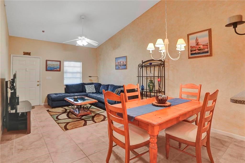 Ready for immediate move-in! This well-maintained 3-bedroom, 2-bathroom condo offers an open and airy feel, enhanced by vaulted ceilings that add to its spaciousness. The extra-large master bedroom features a walk-in closet and a private bathroom with dual vanities. The kitchen includes modern stainless steel appliances and opens to a comfortable living and dining area. A full-size washer and dryer add everyday convenience. Full hurricane protection with accordion shutters provides security and peace of mind. Located in a highly rated school district, with shopping, dining, and major highways just minutes away, this home is perfect for families or couples looking for space and comfort.